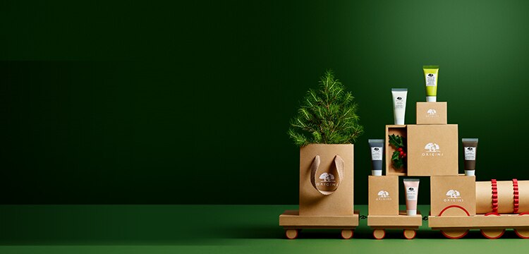 Origins Green The Planet set and pine tree seedling are placed on a carton train. 